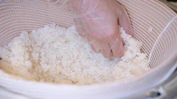 Japanese chef preparing traditional Japanese food tuna sushi in open kitchen. Handmade seafood meal tuna nigiri sushi serve to customer on wooden sushi board on kitchen counter at Japanese restaurant. video