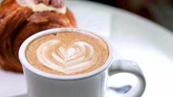 Cup of coffee with latte art pattern milk foam video