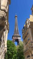 The Eiffel tower with warm rays of light in clouds during sunset timelapse hyperlapse. It is one of the most recognizable landmarks in the world. Blue cloudy sky at sunny evening video