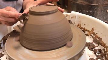 poterie roue le art de fabrication poterie pour cuisine ustensiles aux femmes mains Couper de excès argile copeaux sont visible comme si de Chocolat écoulement de chute comme serpentin potier Maître classe video