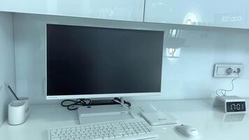 Shop or hospital Laptop with blank screen on table Light simple workspace mockup The monitor is on the table next to the clock. Mouse and keyboard video