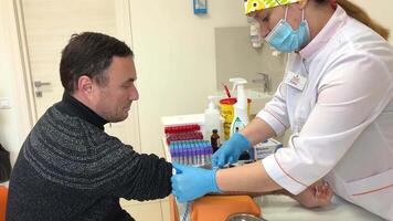 Nurse inserts needle into vein for drip infusion in hospital taking blood from a vein into a modern syringe concept health treat disease cold covid liver tests blood for sugar video