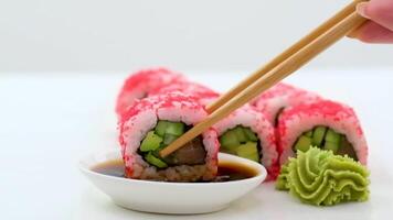 California Maki Sushi with Masago Roll made of Crab Meat, Avocado, Cucumber inside. Masago smelt roe outside video