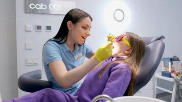 Female dentist shows and explain problem on gypsum model to young woman patient video