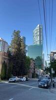 View of downtown Vancouver with skyscrapers, Vancouver lookout and mountains with daily traffic video