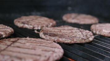 Grilled cutlets Cooking beef burgers. the cook turns the cutlet, close-up video