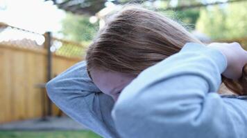 Red-haired girl straightens her hair Close up portrait in profile of young red-haired woman touching her hair. Blonde girl straightens her hair. video