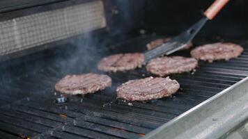 Frozen cutlets Dolly shot of frozen hamburger patties and ingredients lying on kitchen table next to electric grill video