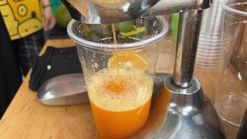 Squeezing juice from green oranges Vietnam street food drinks with ice prepared in unsanitary conditions video