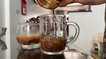 Preparing Vietnamese coffee with condensed milk in a beautiful glass in Vietnam in Ho Chi Minh City drinks video