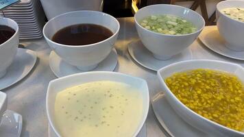 Jelly dessert Liquid sauces in the buffet beautiful white plates many different types of dessert video