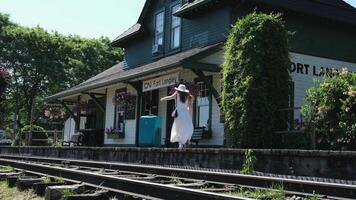 Late for the train girl runs with a suitcase on the platform of the stop video