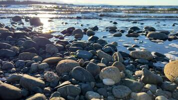 the sun is setting over the stone beach the reflections Pacific Ocean is very quiet and calm there are no waves relaxing music background for titles and advertising Parksville beach Surfside RV resort video