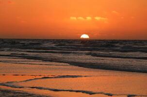 sunset at vlieland, dutch island in the sea photo