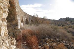 roman aqueduct in antas, spain photo