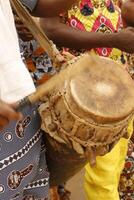 playing drums at festival in Benin photo