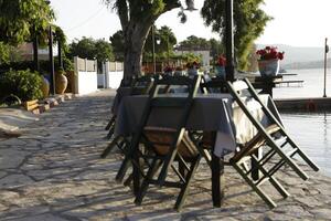 harbor with restaurants in lygia, lefkada, greece photo