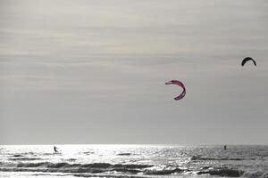 beach in the winter, kitesurfing, in the netherlands photo