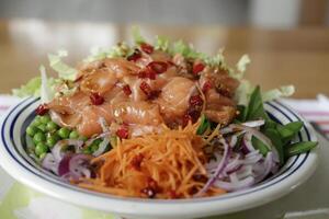 poke bowl with sugarsnaps, peas, red onion, carrot salad, salmon photo