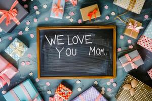 Mother's Day gift and greeting message in a small black board. photo