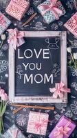 Mother's Day gift and greeting message in a small black board. photo