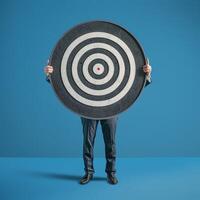 Businessman holding a dart target, dartboard, business goal concept. photo