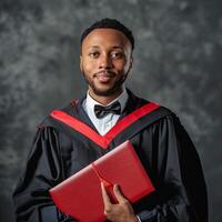 A man wearing graduation gown and holding diploma for ceremony celebration. photo