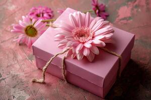 Pink gift box with spring flowers on pink background. photo