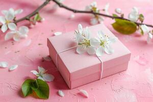 Pink gift box with spring flowers on pink background. photo