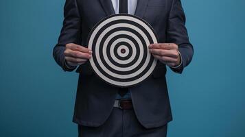 Businessman holding a dart target, dartboard, business goal concept. photo