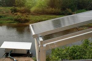 Solar power generation station, they installed several solar panels on a concrete barrier along the river to generate electricity to pump water for agricultural use. photo