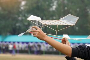 Rubber band powered airplane flies by using the release torque of the rubber to turn the propeller. and lifted up into the air with the force of lift arising from the wings of an airplane. photo