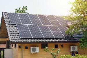 A solar roof system in a building that installs solar panels on the roof of the building. To generate electricity, which will save electricity and reduce global warming. photo