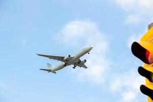 White passenger airplane flying in the sky amazing clouds in the background photo