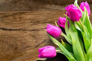 Bouquet of beautiful tulips on wooden background. Tulips on old boards photo