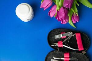 Tools and cosmetics needed for nail styling on a white background. photo