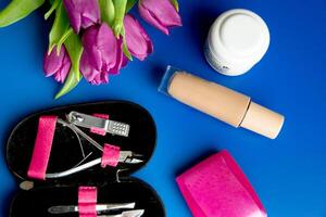 Tools and cosmetics needed for nail styling on a white background. photo