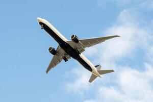 White passenger airplane flying in the sky amazing clouds in the background photo