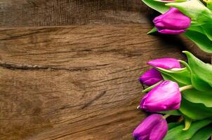 Bouquet of beautiful tulips on wooden background. Tulips on old boards photo