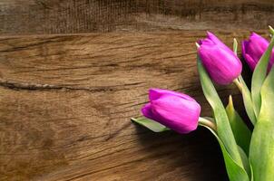 Bouquet of beautiful tulips on wooden background. Tulips on old boards photo