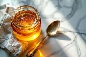 Top view, jar of ghee on a linen napkin with a spoon. photo