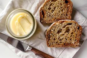 Top view of a jar of ghee and two slices of bread. . photo