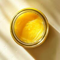Top view of a jar of ghee on a light background. photo