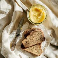 Top view of a jar of ghee and two slices of bread. photo