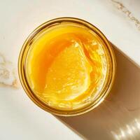 Top view of a jar of ghee on a light background. photo