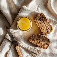 Top view of a jar of ghee and two slices of bread. photo