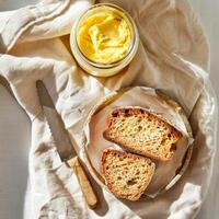 Top view of a jar of ghee and two slices of bread. photo