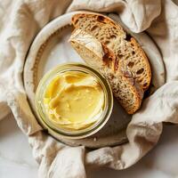 Top view of a jar of ghee and two slices of bread. photo