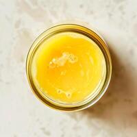 Top view of a jar of ghee on a light background. photo