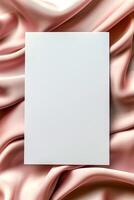 Minimalist aesthetic mockup of white blank A5 envelope on pink silk fabric. photo